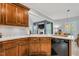 Kitchen featuring dark wood cabinets, white countertops, with view to living room and dining area at 262 Windgate Dr, Clayton, NC 27527