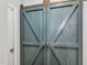Laundry closet featuring sliding barn doors and stacked washer and dryer appliances at 262 Windgate Dr, Clayton, NC 27527