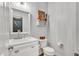 Powder room with a decorative mirror, stylish accents, and a white sink and toilet at 262 Windgate Dr, Clayton, NC 27527