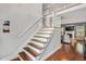 Elegant staircase with hardwood treads, white risers, and a view of the living area at 262 Windgate Dr, Clayton, NC 27527