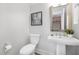 Powder room featuring a pedestal sink, toilet, and decorative artwork at 3022 White Rail Dr, Fuquay Varina, NC 27526