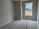 Bright bedroom with a large window and unfinished flooring, offering a blank canvas for customization at 3022 White Rail Dr, Fuquay Varina, NC 27526