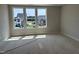 A bright bedroom featuring a large window overlooking the community at 3022 White Rail Dr, Fuquay Varina, NC 27526