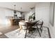Open concept dining room next to kitchen with eat-in bar and modern lighting at 3022 White Rail Dr, Fuquay Varina, NC 27526