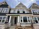 Charming new construction home with stone accents, gray siding, and a welcoming front entrance at 3022 White Rail Dr, Fuquay Varina, NC 27526