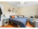 Cozy bedroom with ceiling fan, natural light and comfortable sitting area with grey chair at 304 Cedarwood Ln, Carrboro, NC 27510
