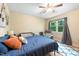 Bright bedroom with ceiling fan, natural light and a cozy sitting area with grey chair at 304 Cedarwood Ln, Carrboro, NC 27510