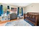 Bedroom featuring a wooden crib, dresser, rug and natural light from the two windows at 304 Cedarwood Ln, Carrboro, NC 27510