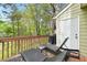 Relaxing deck with outdoor seating, grill, and wooded views, perfect for enjoying the outdoors at 304 Cedarwood Ln, Carrboro, NC 27510