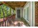 Outdoor deck, wooded views, gray door, and glass door at 304 Cedarwood Ln, Carrboro, NC 27510