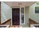 Front door of the house featuring unit number, window and wood trim at 304 Cedarwood Ln, Carrboro, NC 27510