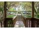 Exterior view of the property showing a wooden walkway and flowering trees at 304 Cedarwood Ln, Carrboro, NC 27510