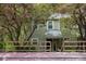 Charming exterior of the house with flowering trees and fence at 304 Cedarwood Ln, Carrboro, NC 27510
