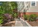 Exterior stairs leading to a deck, surrounded by lush landscaping and greenery at 304 Cedarwood Ln, Carrboro, NC 27510