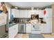 Functional kitchen featuring white cabinets and stainless steel appliances at 304 Cedarwood Ln, Carrboro, NC 27510