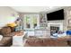 Comfortable living room with fireplace, built-in bookshelves, and access to patio at 304 Cedarwood Ln, Carrboro, NC 27510