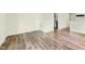 Living room featuring wood-style flooring, bright light, and access to other rooms at 304 Cedarwood Ln, Carrboro, NC 27510