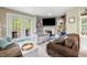 Bright living room with fireplace, built-in bookshelves, and patio access at 304 Cedarwood Ln, Carrboro, NC 27510