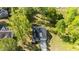 Aerial view of a charming home nestled among lush green trees and expansive lawn at 308 Thorndale Dr, Dunn, NC 28334