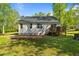 A cozy backyard featuring a wooden deck and brick patio, perfect for outdoor entertaining and relaxation at 308 Thorndale Dr, Dunn, NC 28334