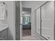 Bright bathroom with a glass enclosed shower and open doorway to bedroom at 308 Thorndale Dr, Dunn, NC 28334