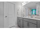 Bright bathroom with gray vanity, dual sinks, and window with decorative valance at 308 Thorndale Dr, Dunn, NC 28334