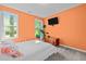 Bright bedroom with orange walls, two windows offering natural light, and modern decor at 308 Thorndale Dr, Dunn, NC 28334