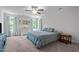 Spacious bedroom features a ceiling fan, neutral walls, and multiple windows with natural light at 308 Thorndale Dr, Dunn, NC 28334