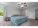 Cozy bedroom with ceiling fan, neutral walls, and doorway to bathroom with shower at 308 Thorndale Dr, Dunn, NC 28334