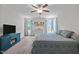Bright bedroom has a ceiling fan, neutral walls, and multiple windows with natural light at 308 Thorndale Dr, Dunn, NC 28334