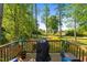 A well-maintained deck featuring a grill and potted plants, offering serene views of the backyard at 308 Thorndale Dr, Dunn, NC 28334