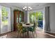 Dining room with a dining table and floral chairs, wood floors, with sliding door access to outdoor deck at 308 Thorndale Dr, Dunn, NC 28334
