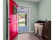 Inviting entryway with a bright red door, a wooden accent table, light green walls, and dark floors at 308 Thorndale Dr, Dunn, NC 28334