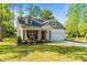 Beautiful house with a lush green lawn, inviting front porch, and a convenient two-car garage at 308 Thorndale Dr, Dunn, NC 28334