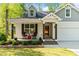 Inviting front porch features a cozy seating area, enhancing the home's curb appeal at 308 Thorndale Dr, Dunn, NC 28334