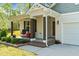 Charming covered porch with dark wood supports and brick platform for outdoor enjoyment at 308 Thorndale Dr, Dunn, NC 28334