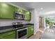 The kitchen features stainless steel appliances, a flat top stove, bright cabinets, and granite countertops at 308 Thorndale Dr, Dunn, NC 28334