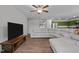 Living room showcasing gray sectional sofa, wood floors, and open to the kitchen, promoting a comfortable living space at 308 Thorndale Dr, Dunn, NC 28334