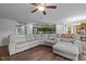 Spacious living room features a large gray sectional, wood floors, and an open floor plan to the kitchen at 308 Thorndale Dr, Dunn, NC 28334
