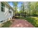 View of the patio featuring a brick paver design, leading to the wooden deck of the home at 308 Thorndale Dr, Dunn, NC 28334