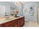 Bathroom featuring a double sink vanity, decorative mirror, and a walk-in shower at 311 Providence Glen Dr, Chapel Hill, NC 27514