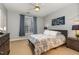 Bedroom with a queen-sized bed, blue accents, and carpeted flooring at 311 Providence Glen Dr, Chapel Hill, NC 27514
