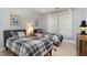 Bedroom featuring two twin beds with plaid comforters, carpeted floors, and window at 311 Providence Glen Dr, Chapel Hill, NC 27514