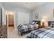 This bedroom features two twin beds, neutral walls and carpet, and a double closet at 311 Providence Glen Dr, Chapel Hill, NC 27514