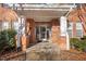 Exterior view of a red brick building entryway with white support columns, and glass doors at 311 Providence Glen Dr, Chapel Hill, NC 27514