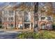 Brick condo building featuring balconies, multiple windows, and well-maintained landscaping at 311 Providence Glen Dr, Chapel Hill, NC 27514