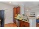 Open kitchen area with granite countertops, wood cabinets, and stainless steel appliances at 311 Providence Glen Dr, Chapel Hill, NC 27514