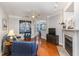 Bright living room with hardwood floors, fireplace, ceiling fan, and view of dining area at 311 Providence Glen Dr, Chapel Hill, NC 27514