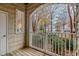 View of a patio with a white railing, and view of the street and houses across the street at 311 Providence Glen Dr, Chapel Hill, NC 27514