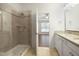 A bathroom showcasing a glass shower, dual vanity, and neutral-toned tile at 317 Castle Rock Ln, Cary, NC 27519
